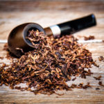 pipe-with-tobacco-wooden-bg